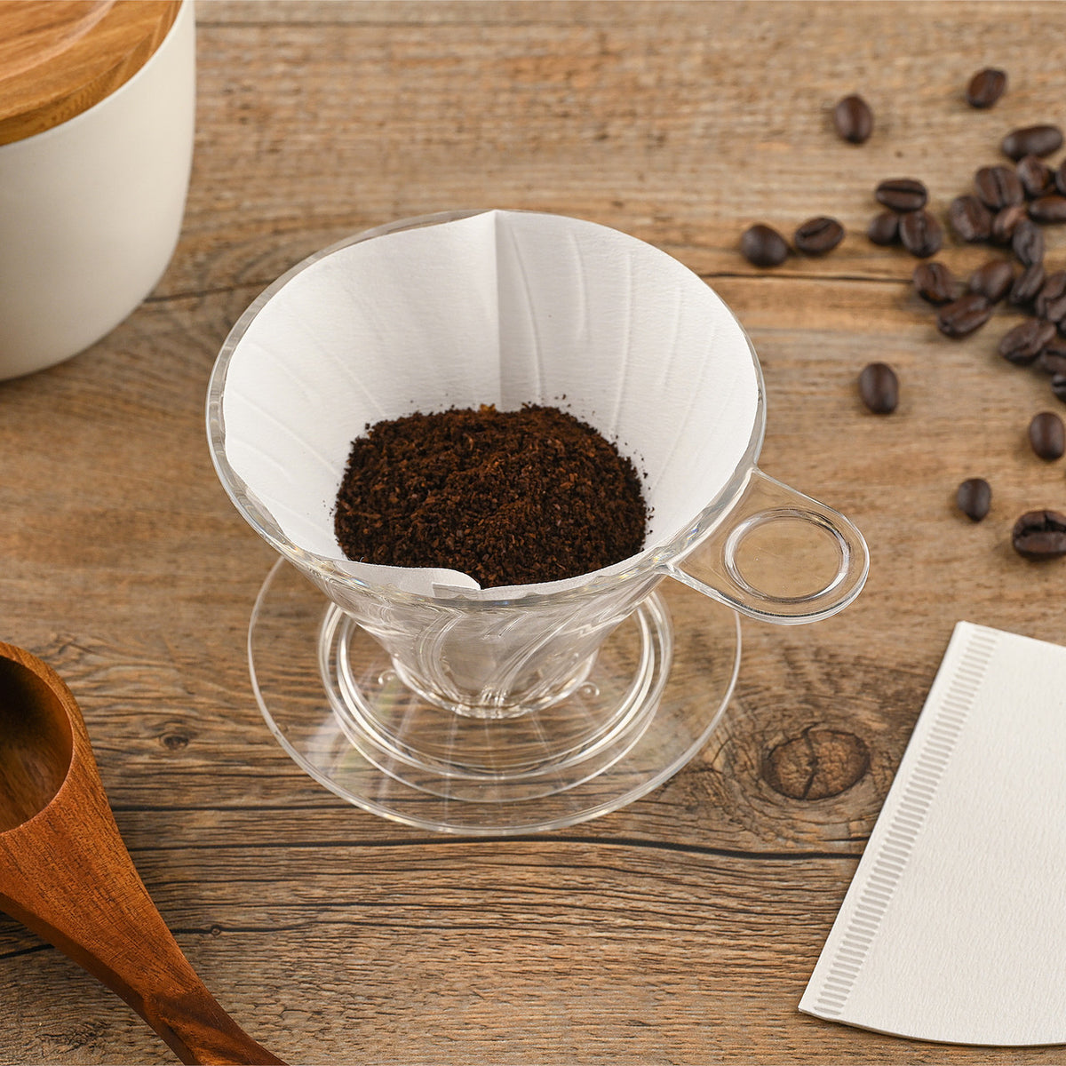 Paper Filter for Cone Dripper, White, 100 pieces, size 01 filter shown formed to cone and placed in plastic dripper on wooden table with coffee beans and ground coffee, PF-100W Select Brands